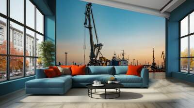 Harbor cargo cranes on evening sky background Wall mural