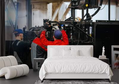 Industrial workers assembles agricultural machinery in workshop Wall mural