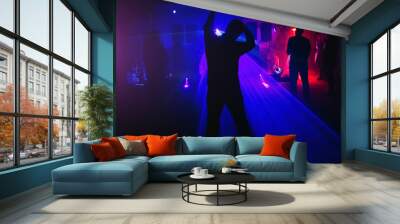 Silhouette of dancing people in the night club disco Wall mural