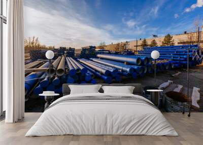 stack of cast iron pipes in loading area waiting for transportation Wall mural