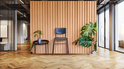 Houseplant and black chair on solid wooden battens wall Wall mural