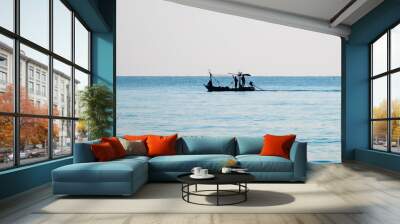 Silhouette fisherman fishing blue sea beautiful natural at morning Wall mural