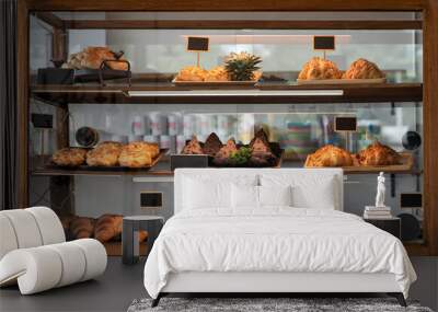 Variety baked bread and dessert in glass showcase at bakery Wall mural