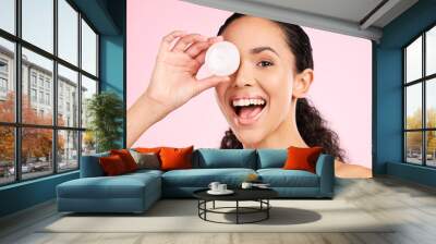 Face, skincare and excited woman with cream container in studio isolated on a pink background. Portrait, natural and happy model with lotion, sunscreen cosmetic and dermatology product for wellness Wall mural