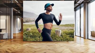 Fitness, running and cardio with black woman in nature for health, workout and challenge. Performance, sports and exercise with female runner training in outdoor for speed, marathon and wellness Wall mural