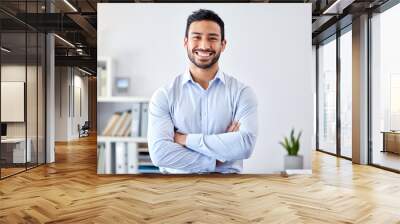 Portrait of a businessman with a smile in a corporate modern office of a startup company. Happy, career and professional manager or entrepreneur standing with his arms crossed in his workspace. Wall mural