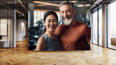 Happy senior korean, asian couple standing together in a gym after exercising Wall mural