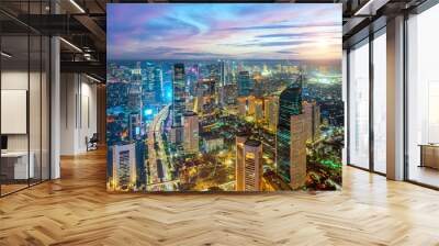 Night aerial view of skyscrapers and multi lane highway in large urban city center Cityscape of high rise buildings in Jakarta, Indonesia at night	 Wall mural