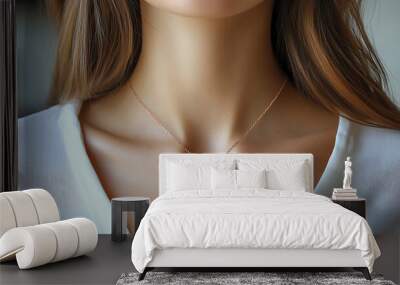 A close-up of a woman's neck featuring a delicate pendant necklace. Wall mural