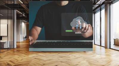 Cloud computing. Uploading process on computer screen. Cloud Data storage and processing. Backup concept. Network cloud service and hosting. Businessman hand touching backup icon on virtual screen. Wall mural