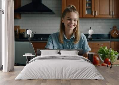 Happy smart teen school girl and positive young mom studying online and cooking salad for dinner at kitchen table, using laptop, chopping vegetables, talking, laughing, having fun Wall mural