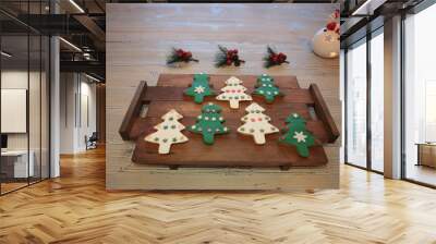 Plate with tasty Christmas cookies on wooden table Wall mural