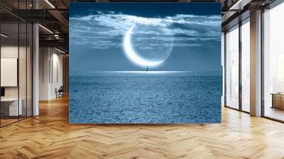 A lonely yacht sails on the sea,  Crescent or new moon  in the background  Wall mural