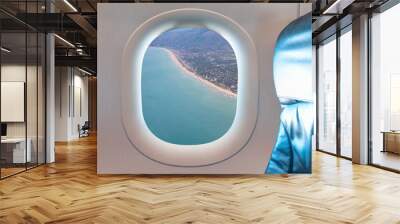 Airplane flying over beach of Gava as seen through window of an aircraft - Barcelona, Spain Wall mural