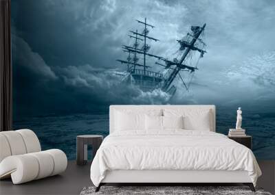 An old sailing ship in the mist sails towards the rocks - Sailing old ship in a storm sea in the background stormy clouds Wall mural