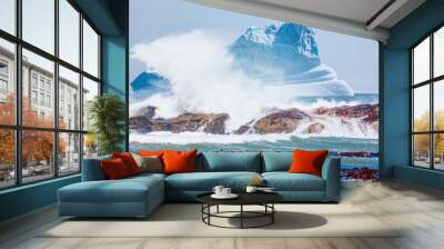 Giant iceberg with rocky coastline and strong sea wave - Greenland Wall mural