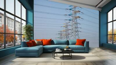 High voltage power line with bulding in thr background Wall mural