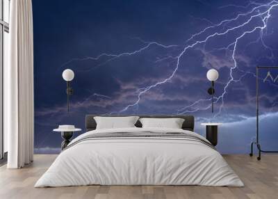 Lightning strikes between stormy clouds. Wall mural