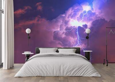 Lightning strikes between stormy clouds. Wall mural