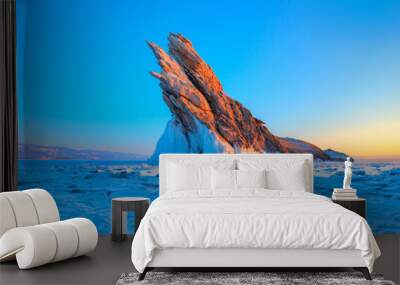 Ogoy island on winter Baikal lake with transparent cracked blue ice at sunrise - Baikal, Siberia, Russia Wall mural