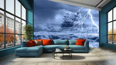 sailing old ship in storm sea on the background heavy clouds with lightning Wall mural