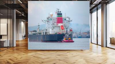 Two tugboats assisting cargo ship Wall mural