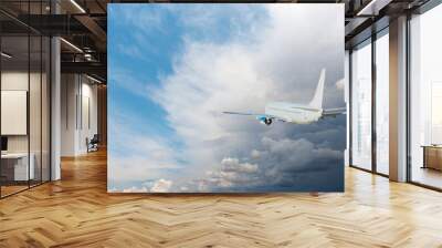 White passenger airplane flying in the sky amazing clouds in the background - Travel by air transport Wall mural