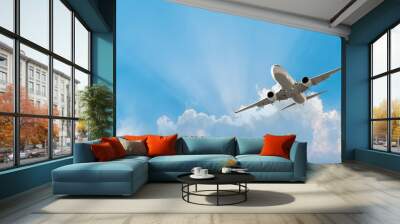 White passenger airplane flying in the sky amazing clouds in the background - Travel by air transport Wall mural