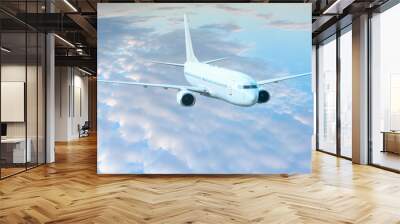 White passenger airplane in the clouds  - Travel by air transport Wall mural