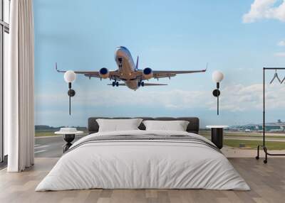 White Passenger plane fly up over take-off runway from airport - Barcelona, Spain Wall mural