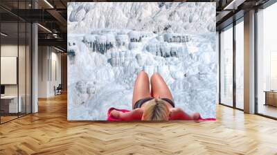 Woman sunbathing at Pamukkale - Natural travertine pools and terraces in Pamukkale. Cotton castle - Young girl is walking on the travertines Wall mural