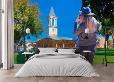 Young girl take a selfie near Topkapi Palace with bright blue sky - Istanbul, Turkey Wall mural