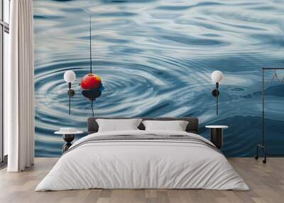 a image of a red and yellow fishing float floating in a body of water Wall mural