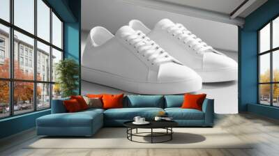 Two white leather sneakers on white background. Wall mural