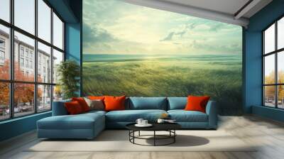 Windswept grass field under cloudy sky. Wall mural