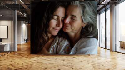 Portrait of a loving couple of middle-aged lesbians cuddling, embracing tenderly, smiling, their faces express happiness, wellbeing and intimacy, beautiful close-up view and wonderful relationship Wall mural