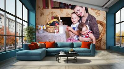 Portrait of mother and two sons in the interior of the kitchen, shot in retro style. Wall mural