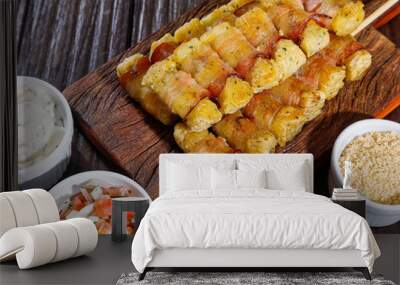 Cassava skewers wrapped in bacon, cassava medallion. Wall mural