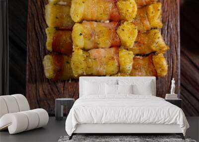 Cassava skewers wrapped in bacon, cassava medallion. Wall mural