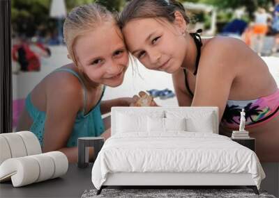 happy sisters eating on the beach  Wall mural