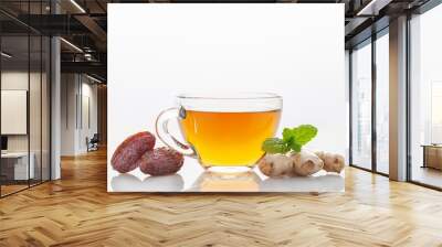 Hot warming tea with dates and ginger in a glass cup on the table. Immune drink Wall mural