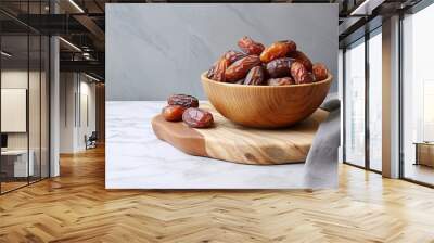 sweet dates out of wooden bowl on marble surface Wall mural