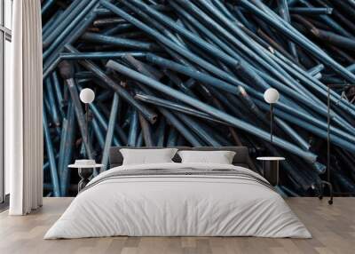 A close-up view of a pile of scrap metal rods. Wall mural