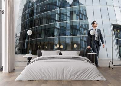 A businessman man goes to work in the office, in a business suit with a briefcase Wall mural