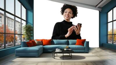 A positive curly-haired woman smiles portrait uses a telphone, isolated transparent background. Wall mural