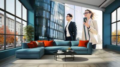 Colleagues are successful partners, managers going to the office for a meeting in business suits. Wall mural