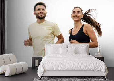 People are friends running together a man and a woman in fitness clothes. Sports couple coach and client doing a workout. Healthy and active lifestyle. Isolated background. Wall mural