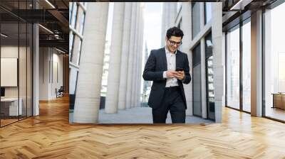 Uses a phone from a businessman a man in a business suit goes to work in the office Wall mural