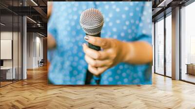 Close up hand holding a microphone Wall mural