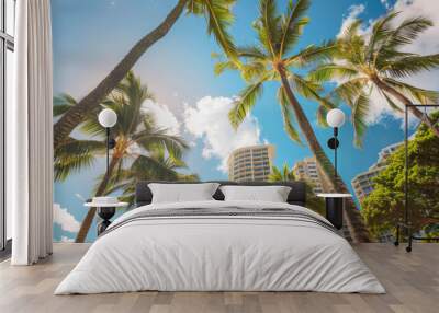 Beautiful Waikiki Beach in Hawaii, with towering buildings and lush palm trees against the blue sky. Wall mural